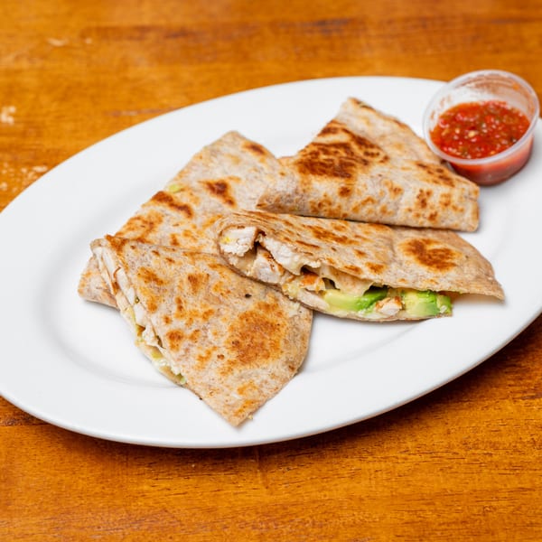 Chicken and avocado quesadillas with melted cheese on a white plate, served with a side of salsa.
